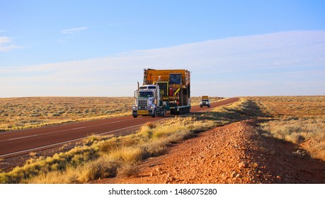 Truck Oversize Rides On Road. Large Truck Driven Mining Dumper. 