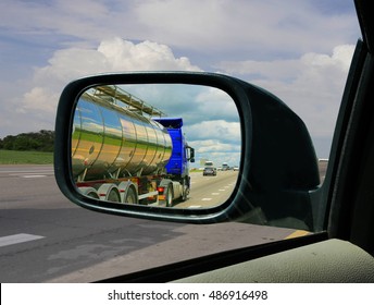 Truck In The Rearview Mirror. Overtaking Maneuver