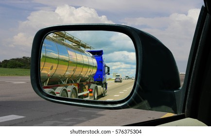 Truck In The Rearview Mirror. Overtaking Maneuver