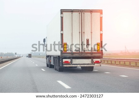 Similar – Foto Bild Lastwagen mit Kühlsattelauflieger auf einem Viadukt über einen Sumpf, Landschaft.