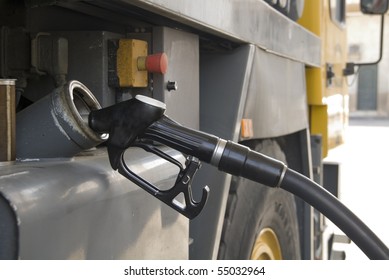 a truck refueling at a gas station before you travel