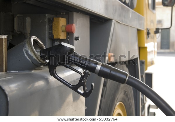 a\
truck refueling at a gas station before you\
travel