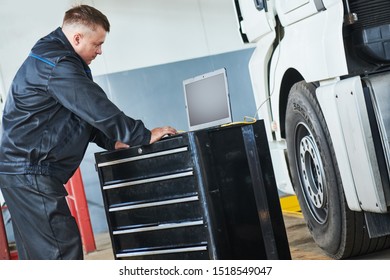 Truck Repair Service. Mechanic Makes Computer Diagnostic Of The Semitruck