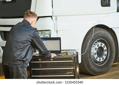 Truck Repair Service. Mechanic Makes Computer Diagnostic Of The Semitruck
