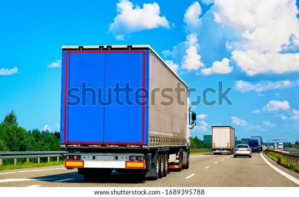 Truck in the road of Poland. Lorry transport\
delivering some freight\
cargo.