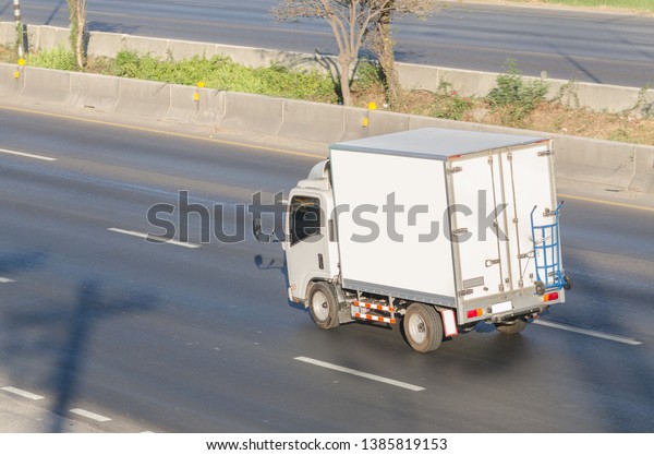 truck\
running on the road, small truck on the\
road.