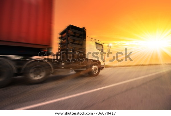 truck running on the road with the sun\
background , transportation concept\
