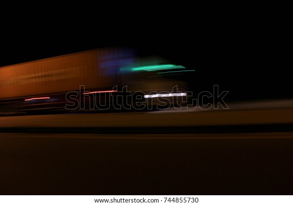 The\
truck runs at night and uses a slow shutter\
speed.