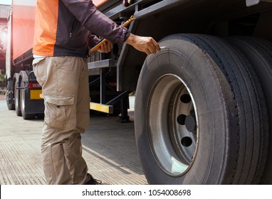 Truck Safety, Truck Driver Holding Clipboard With Checking Safety Of Tire Truck. 