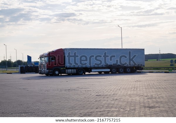 Truck with\
Semi-trailer is parked at the gas station. Goods Delivery logistics\
by roads. Services and\
logistics