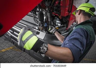 Truck Service Oil Level Check By Caucasian Worker Technician. Semi Truck Maintenance.