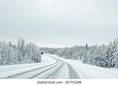 Truck in a snow covered road to Kuolio in Finland on the Arctic pole circle in winter