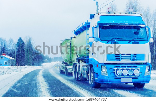 Truck in\
the Snow Road at winter Finland of\
Lapland.