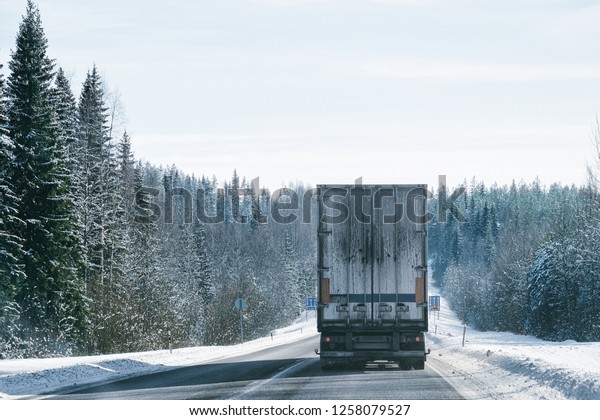 Truck\
at the Snowy winter driveway in Finland,\
Lapland.