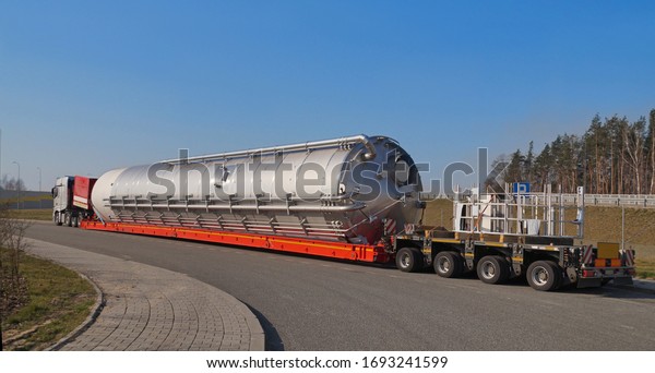 A truck with a\
special semi-trailer for transporting oversized loads. Oversize\
load or exceptional convoy. 