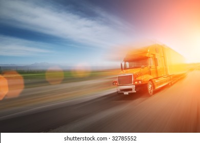 Truck speeding on freeway at sunset. Blurred motion.