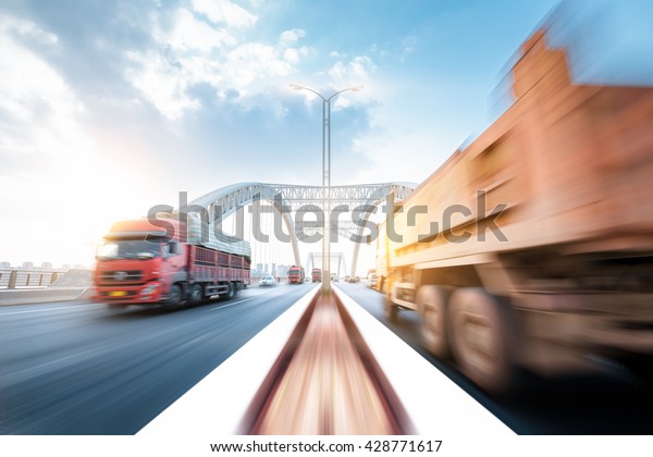 truck\
speeding through a bridge at sunset, motion\
blur.