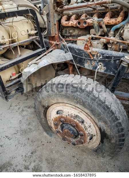 Truck stands with a broken\
wheel
