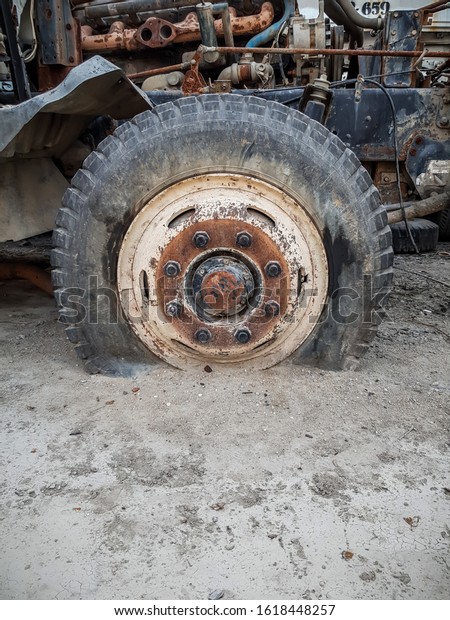 Truck stands with a broken\
wheel