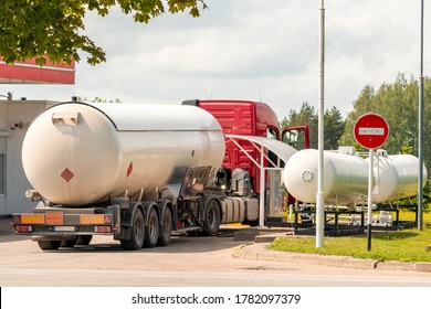 Truck With A Tank For Propane Or Other Fuel. Unloading At A Gas Station