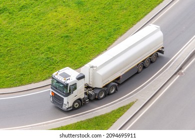 Truck With Tank Trailer And Fuel Turns On City Highway, Aerial View