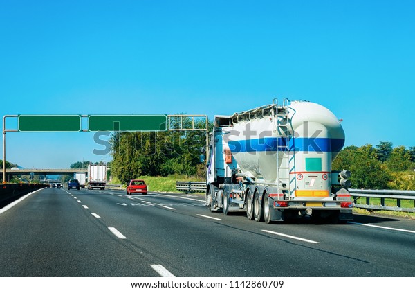 Truck tanker at the road in Italy. Lorry\
transport delivering some freight\
cargo.