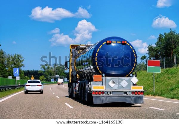 Truck tanker in the road of Poland. Lorry\
transport delivering some freight\
cargo.