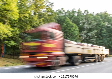 The Truck That Transports Various Construction Materials Is Moving At A Very High Speed. Out Of Focus