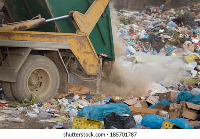 Truck Tipping Garbage From Container On Junk Yard