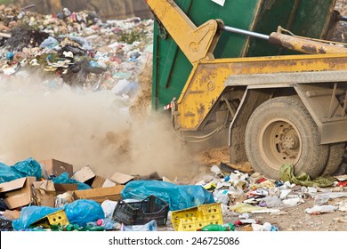 Truck Tipping Garbage From Container On Junk Yard 