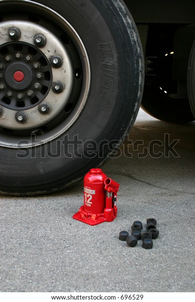 Truck tire with red lifting\
jack