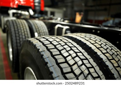 Truck Tires in Assembly line. Tires for Heavy duty trucks in lorry industrial plant. Tire tread of rubber wheel. Rubber tire for truck. New Tyres for lorry.  Assembly line truck factory. Manufacturing