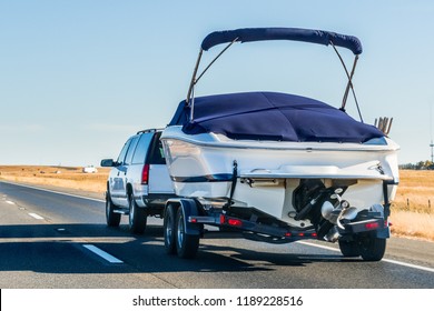 Truck towing a  boat on the interstate, California