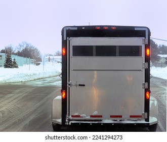 truck towing horse trailer in winter driving conditions hauling horse trailer in winter snowy slippery roads dangerous and hazardous conditions during snow storm on wet snowy roads horizontal format  - Shutterstock ID 2241294273