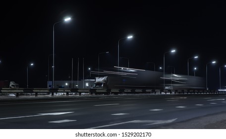 Truck traffic on a winter highway at night