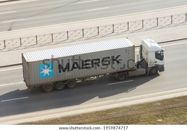 Truck with\
trailer and green container company Maersk on city highway. Russia,\
Saint-Petersburg. 15 april\
2021