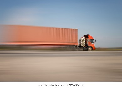 Truck transport container on the road to the port
