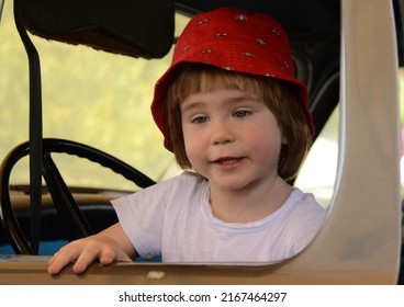 Truck and transport museum. A little boy is driving a vintage Studebaker. Blue retro truck Studebaker transtar. 