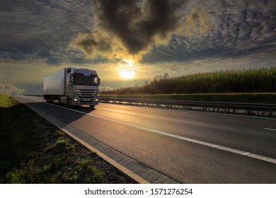 Truck transport on the road at sunset and cargo