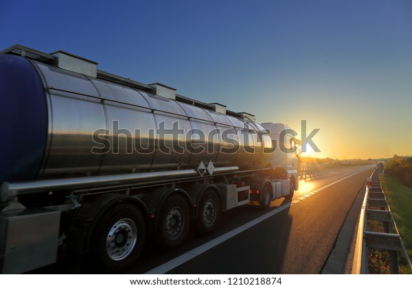 Truck transport on the\
road at sunset