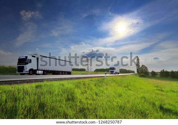 Truck transport\
on the road at sunset and\
cargo