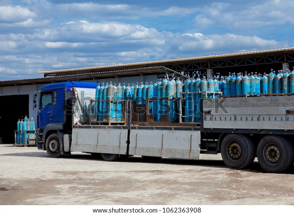 Truck for transportation of gas\
cylinders. The car delivers gas to the shops, restaurants and\
residents of the city. Truck before unloading gas\
cylinders