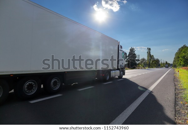 Truck\
transportation on the road at sunset\
