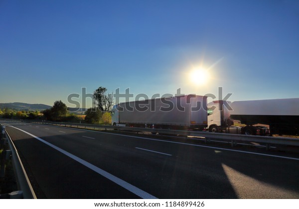 Truck\
transportation on the road at sunset\
