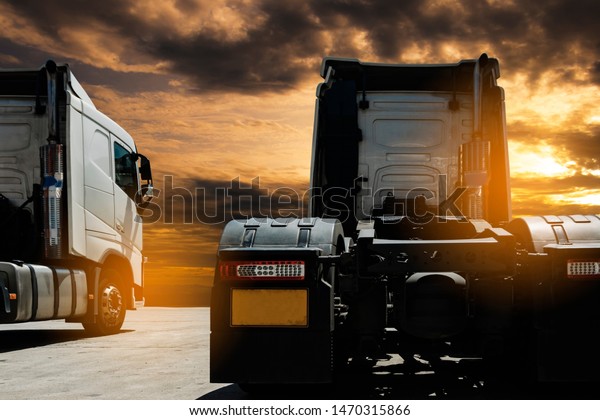 Truck\
transportation, semi truck parking at sunset\
sky