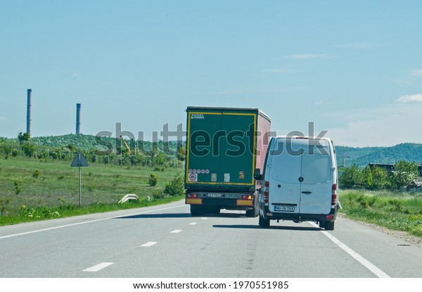 Truck\
transporting goods in traffic. It engages in a dangerous\
overtaking. Romania, Severin. May, 07,\
2021