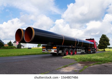 Truck Transporting Large Steel Oil And Gas Pipes, Excessive Load And Heavy Delivery Concept