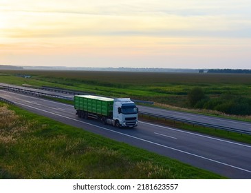 Truck Transports Grain In A Trailer. Truck With Tipper Semi Trailer Driving On Highway. Dump Semi-Trailer Rear Tipper Truck Trailer. Transportation Of Corn And Wheat During The World's Crisis.