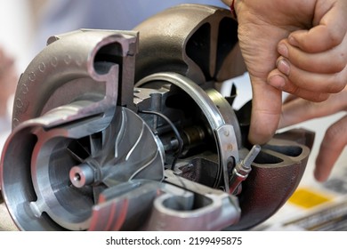 Truck turbo compressor cut. Inside of a car part. Human hand. - Shutterstock ID 2199495875