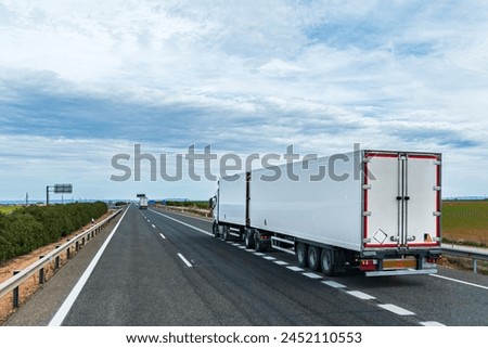 Similar – Foto Bild Lastwagen mit Kühlsattelauflieger auf einem Viadukt über einen Sumpf, Landschaft.